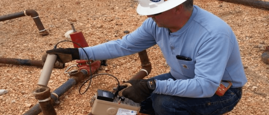 technician testing a pipe